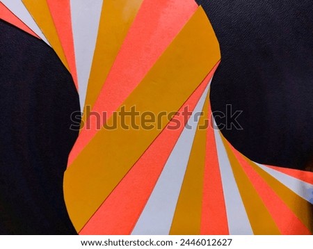 Bandung, Apr 04, 2024 : Concept of colorful abstract curve line pattern from used cardboard cake box cutting with black leather maps for background at home.