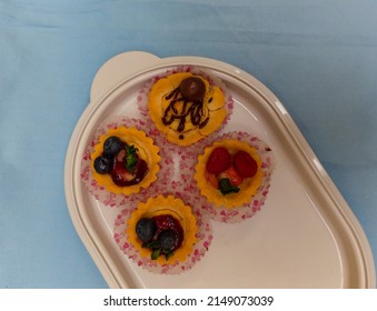 Bandung, Apr 23, 2022 At 13.07 Pm : A Verious Kinds Of Pie Cake With Fruit Toping Served On White Tray. Photo Taken On Table With Light Blue Table Cloth At Home.