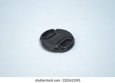 Bandung, August 2022: Camera Lense Cap On Isolated White Background. Camera Lense Cap Is An Accesories That Used To Cover Lense From Dust Or Dirt