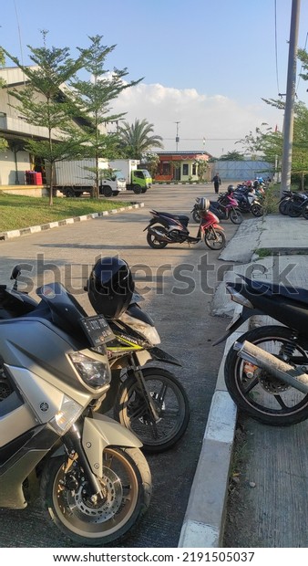 Bandung,\
Indonesia - August 18, 2022: the atmosphere of the parking lot in\
the manufacturing company in the\
afternoon
