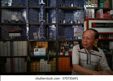 BANDUNG, INDONESIA, JANUARY 2009 : A Man Selling Cigarettes In His Grocery Shop