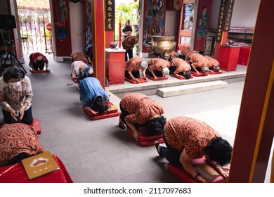 Bandung, Indonesia - January 8, 2022: The congregation and the visitors have a prostration while praying in the temple at Buddhist New Year