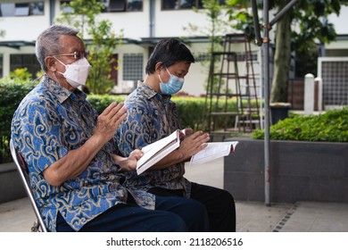 Bandung, Indonesia - January 8, 2022: Old People Praying Peacefully On Buddhist Temple At Buddhist New Year