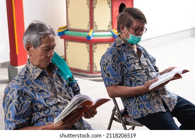 Bandung, Indonesia - January 8, 2022: Old People Praying Peacefully On Buddhist Temple At Buddhist New Year