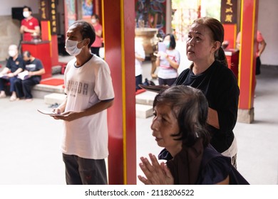 Bandung, Indonesia - January 8, 2022: Old People Praying Peacefully On Buddhist Temple At Buddhist New Year