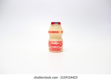 BANDUNG, INDONESIA – MAY 22,  2022 Yakult, Yogurt-like Probiotic Drink Made From Fermented Skim Milk And Sugar With Lactobacillus Casei Bacteria. Yakult On A White Background