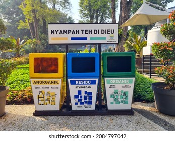 Bandung, Indonesia. October 31, 2021. 3 trash cans with different colors located in the city park.  Yellow is for inorganic waste, blue is for plastic and styrofoam, and green is for organic waste.
