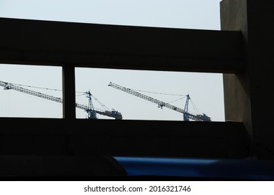 Bandung, Indonesia - Oktober, 11 2015: Framing Crane Through Wall Gap