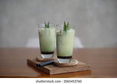 bandung, indonesia on oct 24, 2021: defocused. pandan soft drink on the wooden plate. selective focus