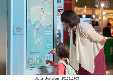 Bandung - West Java
August 19, 2016 
Indonesia

The little girl accompanied by her mother is choosing boxed drinks from the machine box