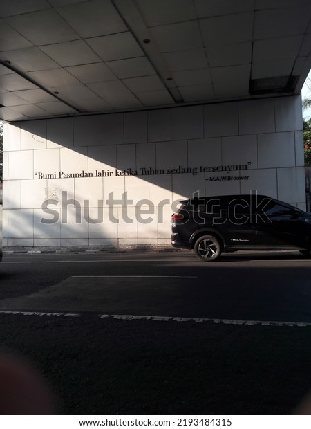 Bandung, west java, indonesia, august 23,\
2022. Street wall with sun shadow\
background