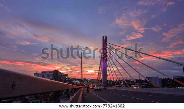 Bandung, West\
Java / Indonesia - December 20 2017 :  Bandung bridge also known as\
pasopati in the evening sunset\

