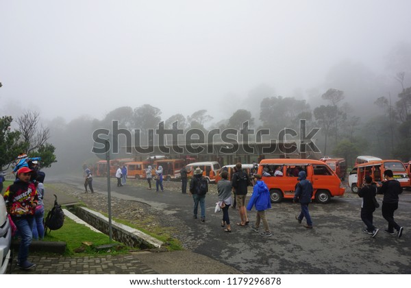 Bandung, West Java, Indonesia - January ,\
2018: Parking area in front of Kawah Putih entrance.Kawah Putih is\
a striking crater lake and tourist spot in a volcanic crater at\
Bandung Indonesia.