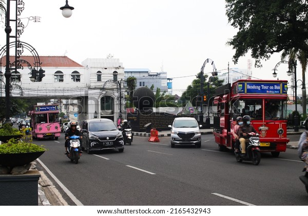 Bandung, West Java, Indonesia - January 10,\
2022: Pink iconic sightseeing bus called Bandros or Bandung Tour on\
the Bus is a tour bus for tourists who want to get around the city\
of Bandung.