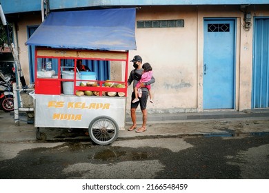 Bandung, West Java Indonesia, October 10, 2021 : young coconut ice traditional cart with its buyers