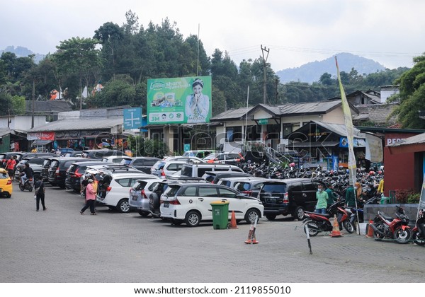 Bandung,\
west java Indonesia-February 8, 2022 : a parking lot full of cars\
and motorbikes in sariater bandung,\
Indonesia