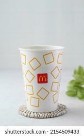 Bandung,Indonesia May10-2022:cold drink product from mcdonald's served in a white glass,blurry background,on white background