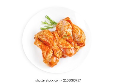 Baner.Cooking chicken drumsticks.Raw chicken legs in a marinade with rosemary on a background.Marinated chicken dramstick with spices for cooking.Top view, copy space.Isolated