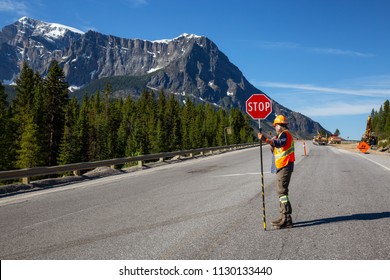 flagger park banff national highway working traffic alberta canada sunny june control during summer shutterstock day