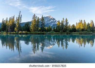Banff National Park beautiful scenery. Cascade Mountain and pine trees reflected on turquoise color Bow River in summer time. Town of Banff, Canadian Rockies, Alberta, Canada.