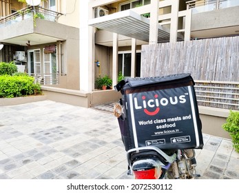 Bangalore, India - Circa 2021 : Bike Delivery Parked In Front Of Flats Houses Homes Showing Hot Box With Licious Logo Showing The Indian Startup Food Tech Delivery Service