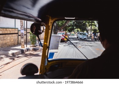 Bangalore, India - June 08, 2020. Rickshaw Driving Through Streets Of Bengaluru India. Driver Taxi And Citizens In Face Mask