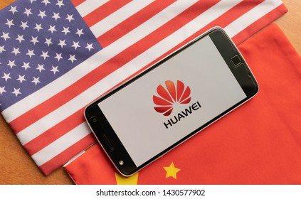 Bangalore, India, June 4, 2019 : Huawei Logo in Mobile, kept on the US and china flag
