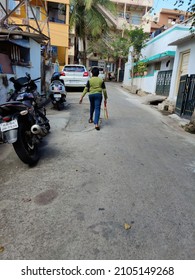 Bangalore, India- November 7th 2020; Back View Of 8 To 10 Year Old Indian Boy Wearing Green Color T Shirt And Blue Color Pant Holding Bag And Walking Toward His Home In The Residential Area At India.