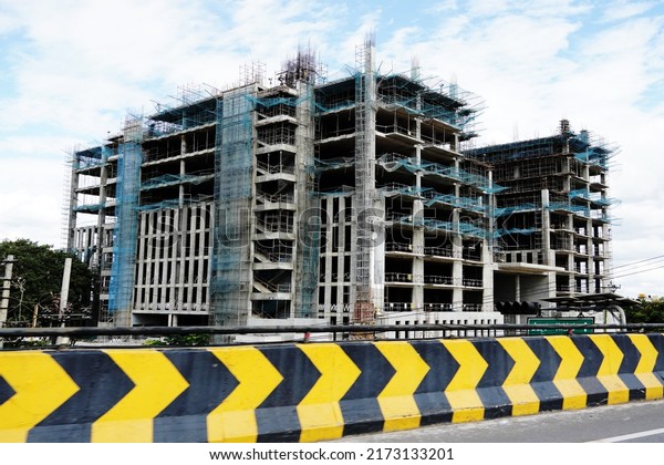 Bangalore, Karnataka, India, June 24, 2022:
Building construction. Street view of an unfinished building by the
roadside.                              
