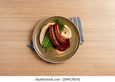 Bangers And Mash food with vegetables, Herbs, and Gravy Top View