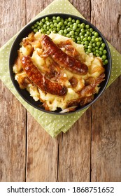 Bangers and mash, also known as sausages and mash, is a traditional dish of Great Britain and Ireland, consisting of sausages served with mashed potatoes and green peas. Vertical top view from above
