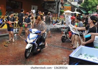 BANGKOK - APRIL 12: Revellers celebrate the Thai New Year near Khao San Road on April 12, 2013 in Bangkok, Thailand. The new year, or Songkran, is celebrated with street parties and water fights.