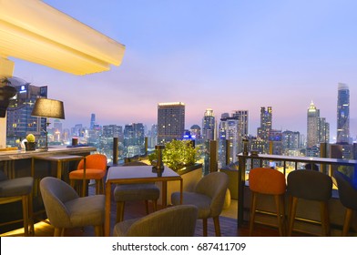 Bangkok city view point from rooftop bar, overlooking a magnificent cityscape blue sky and city light, Thailand