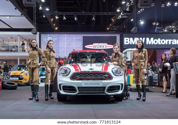 BANGKOK - December 7, 2017 :\
Unidentified model with Mini car on display at The Bangkok\
International Motor Expo 2017 on December 7, 2017 in Bangkok,\
Thailand.