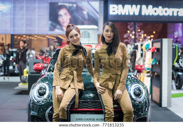BANGKOK - December 7, 2017 :\
Unidentified model with Mini car on display at The Bangkok\
International Motor Expo 2017 on December 7, 2017 in Bangkok,\
Thailand.