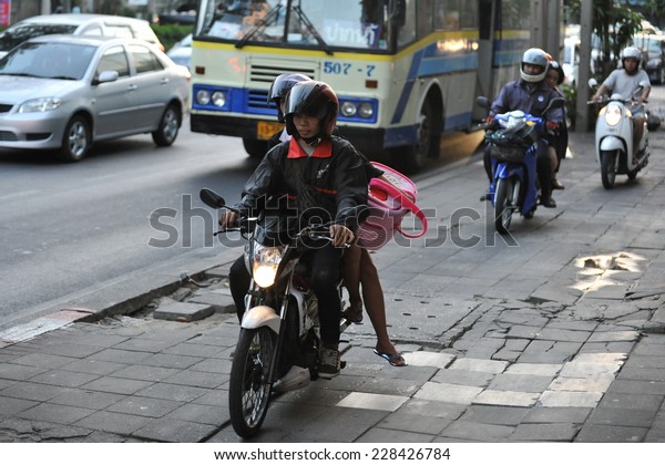 BANGKOK\
- JAN 10: Unidentified motorcyclists ride on a pavement during rush\
hour on Jan 10, 2013 in Bangkok, Thailand. Road traffic laws are\
often poorly enforced and overlooked in\
Thailand.