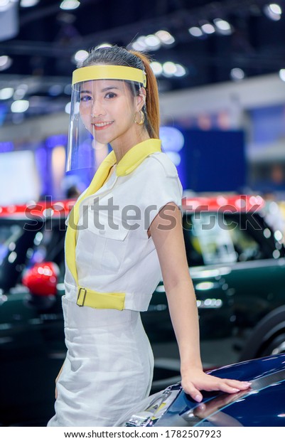 BANGKOK - July 18,\
2020 : Unidentified models with MINI car with face shield on\
display at the 41st BANGKOK INTERNATIONAL MOTOR SHOW 2020 on July\
18, 2020 in Bangkok,\
Thailand.