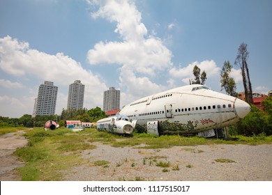 BANGKOK - June 22: Remains Of A Wrecked And Graffitied Boeing 747 And Two McDonnell Douglas MD-80s In A Field In Bangkok, Thailand Never To Be Flown Again. Now Home To A Family.