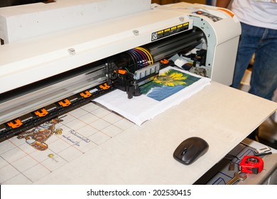 BANGKOK - JUNE 28 :Unidentified Worker Show Digital T-shirt Printer Work With Sewing  Machine At Garment Manufacturers Sourcing 2014 2014 On June 28,2014 In BITEC ,Bangkok,  Thailand.