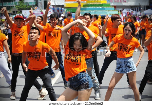 BANGKOK - JUNE 30: A cheerleading flash mob\
dance troupe perform on a city centre street on June 30, 2013 in\
Bangkok, Thailand. Cheerleading dance teams are growing in\
popularity in the Thai\
capital.
