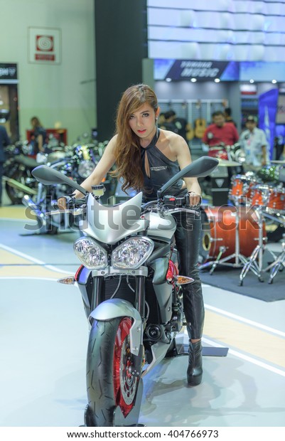 BANGKOK\
- MARCH 22 : Unidentified model with Triumph motorcycle on display\
at The 37th Bangkok International Motor Show : No Boundaries\
Mobility on March 22, 2016 in Bangkok,\
Thailand.
