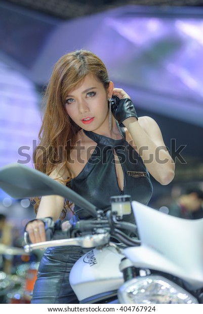 BANGKOK\
- MARCH 22 : Unidentified model with Triumph motorcycle on display\
at The 37th Bangkok International Motor Show : NoÂ Boundaries\
Mobility on March 22, 2016 in Bangkok,\
Thailand.