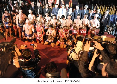 BANGKOK - MARCH 23: Athletes and officials pose for photos during the closing ceremony of the World Amateur Muay Thai Championships at the National Stadium on March 23, 2012 in Bangkok, Thailand. - Shutterstock ID 111034658