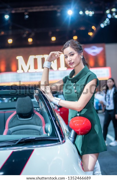 BANGKOK - March 28, 2019 :\
Unidentified models with MINI car on display at the 40th BANGKOK\
INTERNATIONAL MOTOR SHOW 2019 on March 28, 2019 in Bangkok,\
Thailand.   