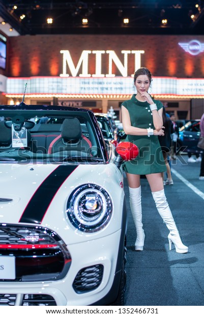 BANGKOK - March 28, 2019 :
Unidentified models with MINI car on display at the 40th BANGKOK
INTERNATIONAL MOTOR SHOW 2019 on March 28, 2019 in Bangkok,
Thailand.   