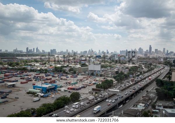 Bangkok Port Customs Bureau, Thailand - JULY 08,\
2017 : Aerial view of traffic in street, left side is the Port\
Customs, right side car runs on the highway, You can see all of\
Bangkok from this\
angle.
