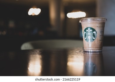 Bangkok, Samut Prakan - June 11, 2022 : A glass of Almondmilk White Chocolate Affogato Frappuccino from Starbucks coffee. Starbucks is the world's largest coffeehouse and is highly popular