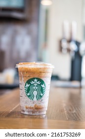 Bangkok, Samut Prakan - May 29, 2022 : A glass of Almondmilk White Chocolate Affogato Frappuccino from Starbucks coffee. Starbucks is the world's largest coffeehouse and is highly popular