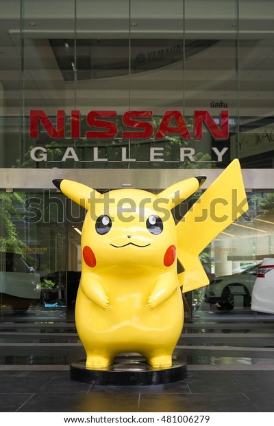 BANGKOK - SEPT 10, 2016 : Giant Mascot of\
Pikachu (scale in human size), standing in front of Nisson Showroom\
in Bangkok. Pikachu is a famous character from Pokemon, Japanese\
successful animation.
