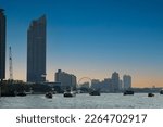 Bangkok skyline cityscape, ferris wheel, riverfront building, boat, ship transportation at twilight dusk
